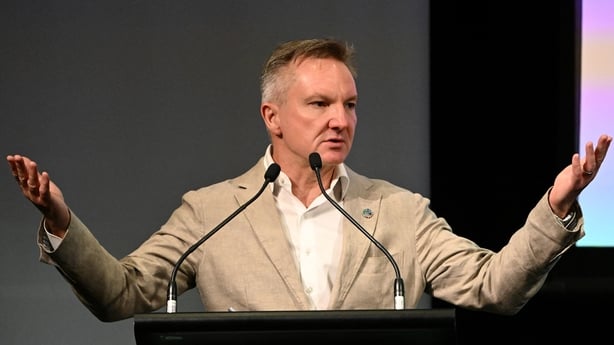 Chris Bowen addressing the pre-COP summit with his arms out wide and a stern look on his face